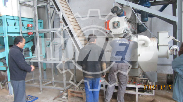 the workers test the pellet mill